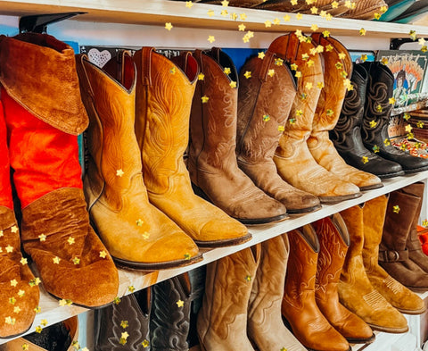 Cool Vintage Cowboy boots lined up perfectly on shelves. Many different shapes, colors, and styles 