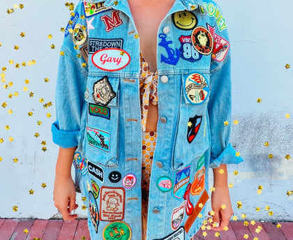 Oversized denim jacket filled with unique and colorful vintage patches all over the front. 