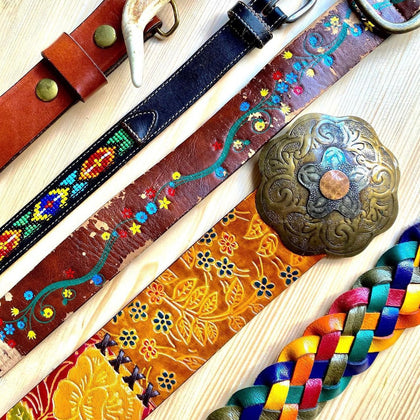 Beautiful unique vintage leather belts with beading and floral details, all bright and colorful. 